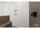 Modern bathroom with a walk-in shower and built-in shelves at 2205 Catalina Ave, Charlotte, NC 28206