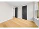 Bright bedroom featuring hardwood flooring and modern doors, enhancing the contemporary design at 2205 Catalina Ave, Charlotte, NC 28206