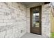 Front entrance with stone facade and a modern wood door at 2205 Catalina Ave, Charlotte, NC 28206