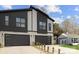 Modern three-unit building with stone and dark siding, two-car garages at 2205 Catalina Ave, Charlotte, NC 28206