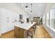 Modern kitchen with large island, white cabinets, and hardwood floors at 2205 Catalina Ave, Charlotte, NC 28206