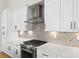 Modern kitchen with stainless steel appliances and herringbone tile backsplash at 2205 Catalina Ave, Charlotte, NC 28206