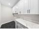 Laundry room with white cabinets and quartz countertops at 2205 Catalina Ave, Charlotte, NC 28206