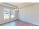 Bright dining room with modern chandelier, hardwood floors, and large windows with neighborhood view at 251 Winford Rd, Troutman, NC 28116