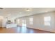 Open-concept living area with hardwood floors, modern lighting, and view into the kitchen at 251 Winford Rd, Troutman, NC 28116