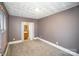 Simple bedroom with carpet, neutral walls, and ensuite bathroom at 317 W Main St, Marshville, NC 28103