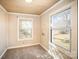 Well-lit bedroom with wood paneled walls and carpet at 317 W Main St, Marshville, NC 28103