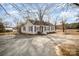 Charming white house with gray trim and a gravel driveway at 317 W Main St, Marshville, NC 28103