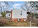 Rear view of house with covered porch, storage shed and fenced yard at 317 W Main St, Marshville, NC 28103