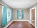 Living room with hardwood floors and two windows at 317 W Main St, Marshville, NC 28103