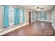 Living room with hardwood floors and teal curtains at 317 W Main St, Marshville, NC 28103