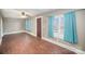 Bright living room with hardwood floors and teal curtains at 317 W Main St, Marshville, NC 28103