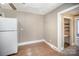 Small pantry with shelving and tiled floor at 317 W Main St, Marshville, NC 28103