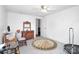 Bright bedroom with ceiling fan, vintage desk and an eye-catching round rug at 335 Ridgewood Dr, Mt Ulla, NC 28125