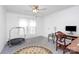 A light-filled bedroom with a ceiling fan, and a round decorative rug at 335 Ridgewood Dr, Mt Ulla, NC 28125