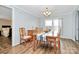 A well-lit dining room featuring a wooden table, six chairs, and hardwood flooring at 335 Ridgewood Dr, Mt Ulla, NC 28125