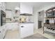 A compact kitchen with white cabinetry, an island cooktop, and modern appliances at 335 Ridgewood Dr, Mt Ulla, NC 28125