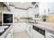 An L-shaped kitchen with white cabinetry, modern appliances, and unique backsplash at 335 Ridgewood Dr, Mt Ulla, NC 28125