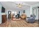 Bright living room features hardwood flooring, ceiling fan, and comfortable seating at 335 Ridgewood Dr, Mt Ulla, NC 28125