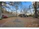 Large backyard with gravel and mature trees at 352 Leafmore Dr, Charlotte, NC 28213