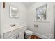 Clean bathroom with a toilet, sink, and vanity at 352 Leafmore Dr, Charlotte, NC 28213