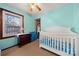 Charming bedroom with a crib, dresser, and ample closet space at 352 Leafmore Dr, Charlotte, NC 28213