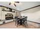 Dining area features a fireplace, seating and a view into the kitchen at 352 Leafmore Dr, Charlotte, NC 28213