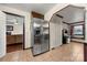 Stainless steel refrigerator in kitchen with tile floors and access to living area at 352 Leafmore Dr, Charlotte, NC 28213