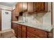 Kitchen features granite countertops, wooden cabinets, and a stylish backsplash at 352 Leafmore Dr, Charlotte, NC 28213