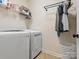 Bright laundry room with washer, dryer, shelving and hanging rod at 1419 Imperial Court Imperial Ct, York, SC 29745