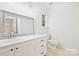 Well-lit bathroom with a vanity, framed mirror, and neutral tiling at 14922 Deshler Ct, Charlotte, NC 28273