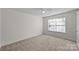 Bright bedroom with neutral carpeting and large window at 14922 Deshler Ct, Charlotte, NC 28273