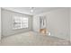 Bedroom with neutral carpeting and access to another room at 14922 Deshler Ct, Charlotte, NC 28273