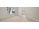 A carpeted bedroom with an open door and window at 14922 Deshler Ct, Charlotte, NC 28273