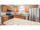 Close-up of a kitchen with stainless steel appliances, wooden cabinets, and granite countertops at 14922 Deshler Ct, Charlotte, NC 28273