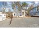 Quaint home with gray siding and stone accents, nestled among trees at 151 Dogwood Cir, New London, NC 28127