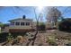 Back exterior of home features enclosed porch, deck, and stairs down to lawn at 16425 Grapperhall Dr, Huntersville, NC 28078