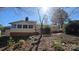 Back exterior view featuring a cozy sunroom and a wooden deck, perfect for outdoor relaxation at 16425 Grapperhall Dr, Huntersville, NC 28078
