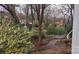 Secluded backyard with brick pathways, shed, mature trees and flourishing foliage at 16425 Grapperhall Dr, Huntersville, NC 28078