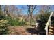 The multi-level backyard has stairs and a brick patio area surrounded by mature trees at 16425 Grapperhall Dr, Huntersville, NC 28078