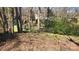 Landscaped backyard featuring a white fence and mature trees providing shade and privacy at 16425 Grapperhall Dr, Huntersville, NC 28078