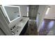 Beautiful bathroom featuring double sinks, modern fixtures and glass enclosed shower at 16425 Grapperhall Dr, Huntersville, NC 28078
