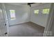 Neutral bedroom with carpeting and three windows for ample natural light at 16425 Grapperhall Dr, Huntersville, NC 28078