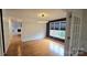 Bright dining room features hardwood floors, natural light, and modern lighting fixture at 16425 Grapperhall Dr, Huntersville, NC 28078