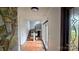 Inviting entryway showcasing tiled floors, a stone accent wall, and an elegant staircase at 16425 Grapperhall Dr, Huntersville, NC 28078