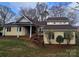 Charming two-story home featuring a well-manicured front yard, inviting curb appeal, and great natural light at 16425 Grapperhall Dr, Huntersville, NC 28078