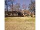 Charming ranch-style home with a welcoming front porch and mature trees on a large lot at 16425 Grapperhall Dr, Huntersville, NC 28078