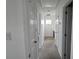 Bright hallway featuring neutral carpet and white trim throughout the interior at 16425 Grapperhall Dr, Huntersville, NC 28078