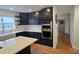 Well-equipped kitchen boasting stainless steel appliances, stylish cabinetry, and bright countertops at 16425 Grapperhall Dr, Huntersville, NC 28078