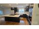 Well-appointed kitchen with stainless steel appliances, dark cabinets, and a central island at 16425 Grapperhall Dr, Huntersville, NC 28078